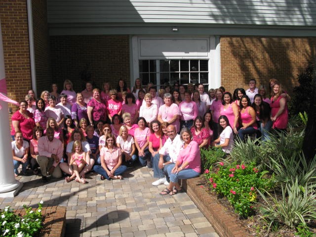 Group of employees wearing pink