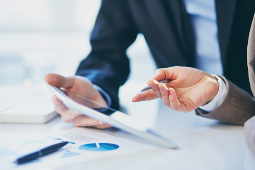 Two people discussing data on paper