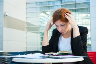 Stressed woman reading a book.