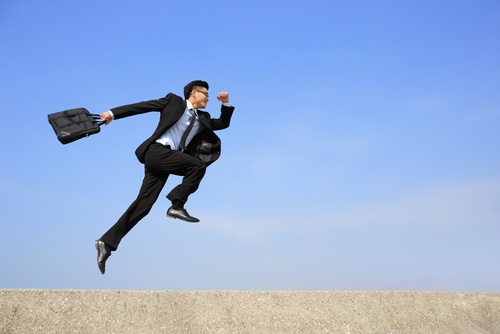 Business man jumping and running in the air.